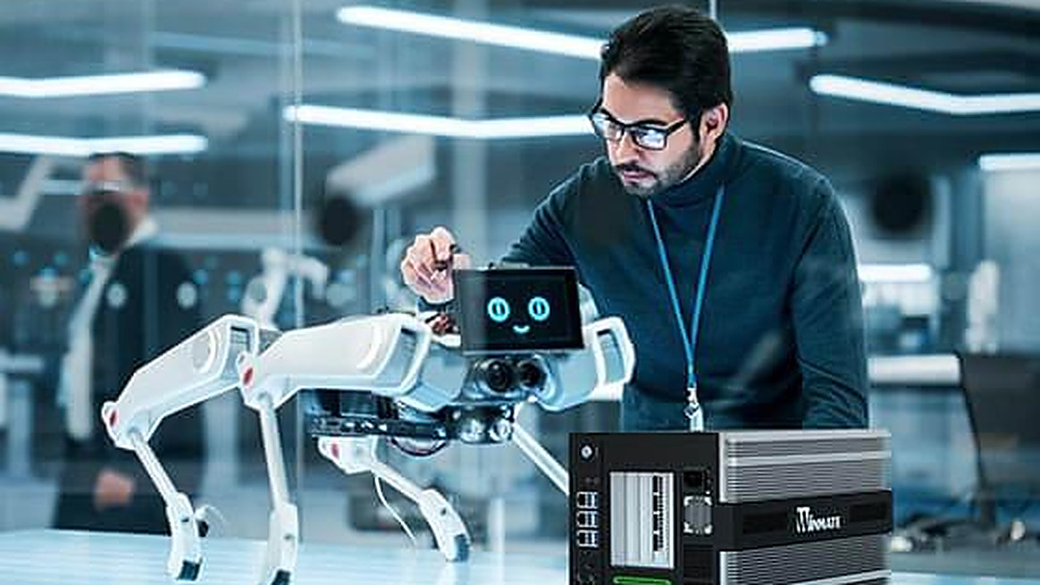 Engineer assembling a quadruped robot next to an edge AI compute unit